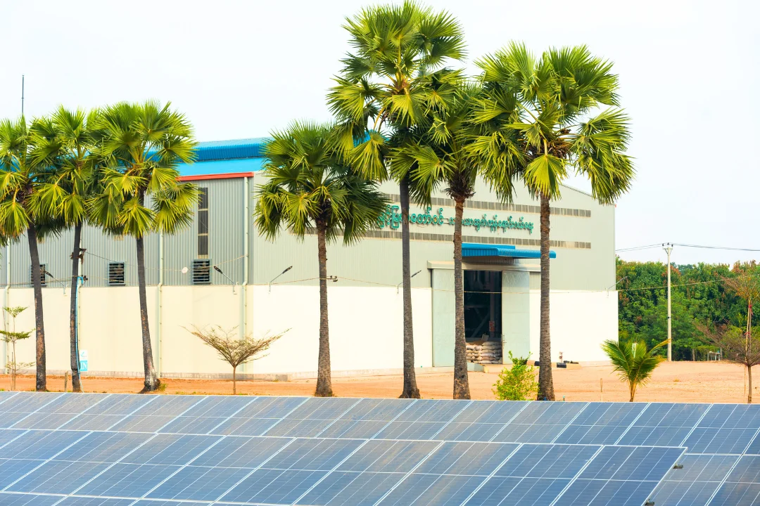 MMTW facility building with solar panels and palm trees