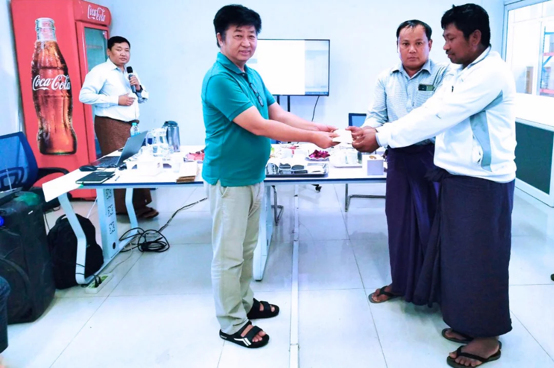 Managing Director exchanging documents with farmer representative